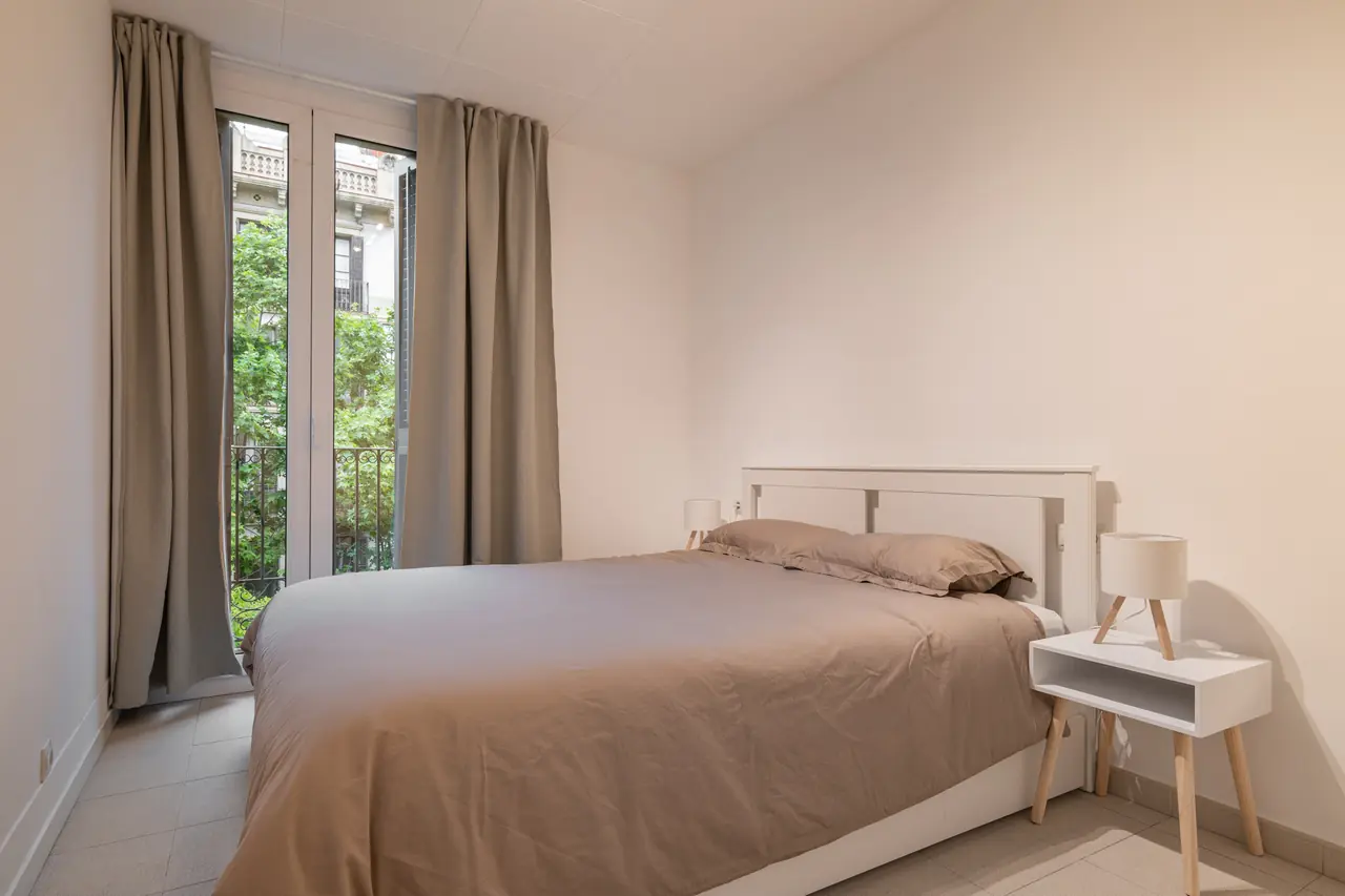 Bedroom with a double bed and tall window