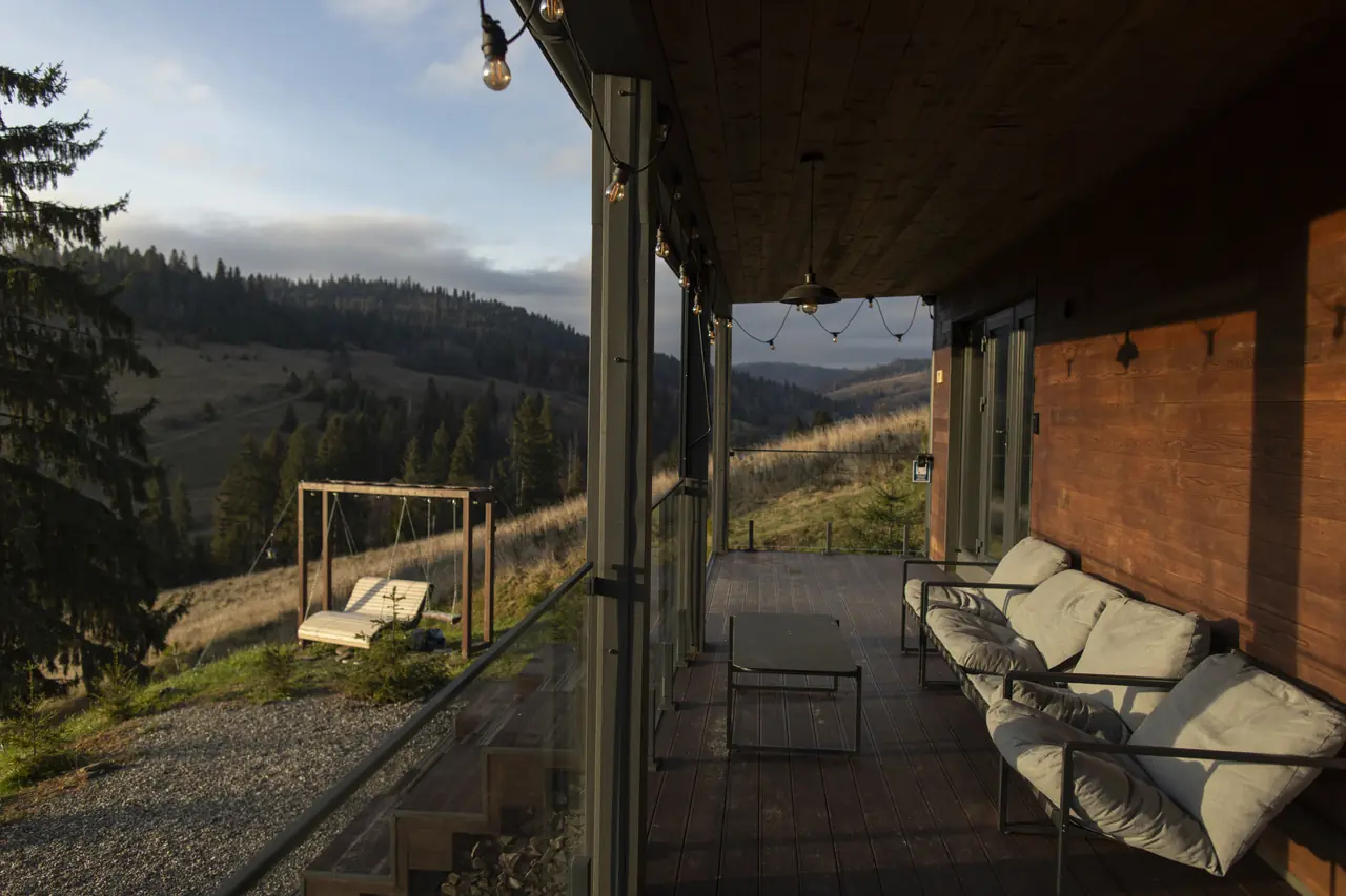 Covered deck with outdoor lounge overlooking hills