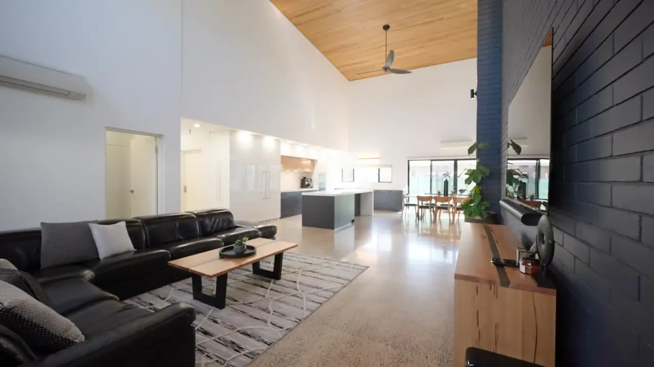 Open-plan living room with a timber ceiling