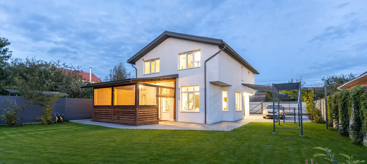 Two-storey home lit at dusk